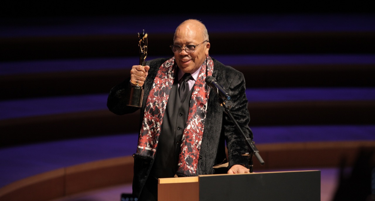 Quincy Jones accepting an award on stage